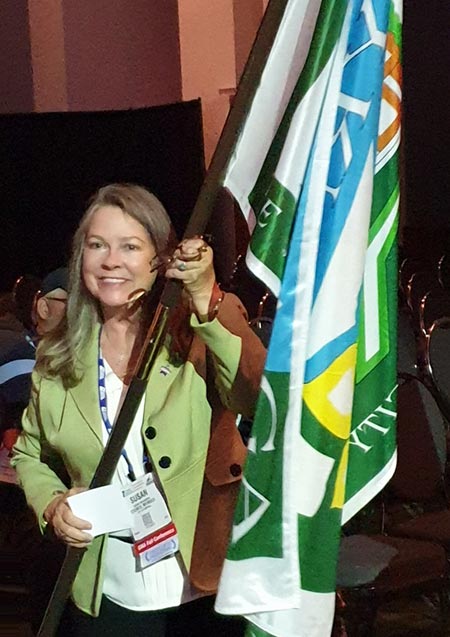 Susan carries the Smyrna flag at the Georgia Municipal Association annual conference.